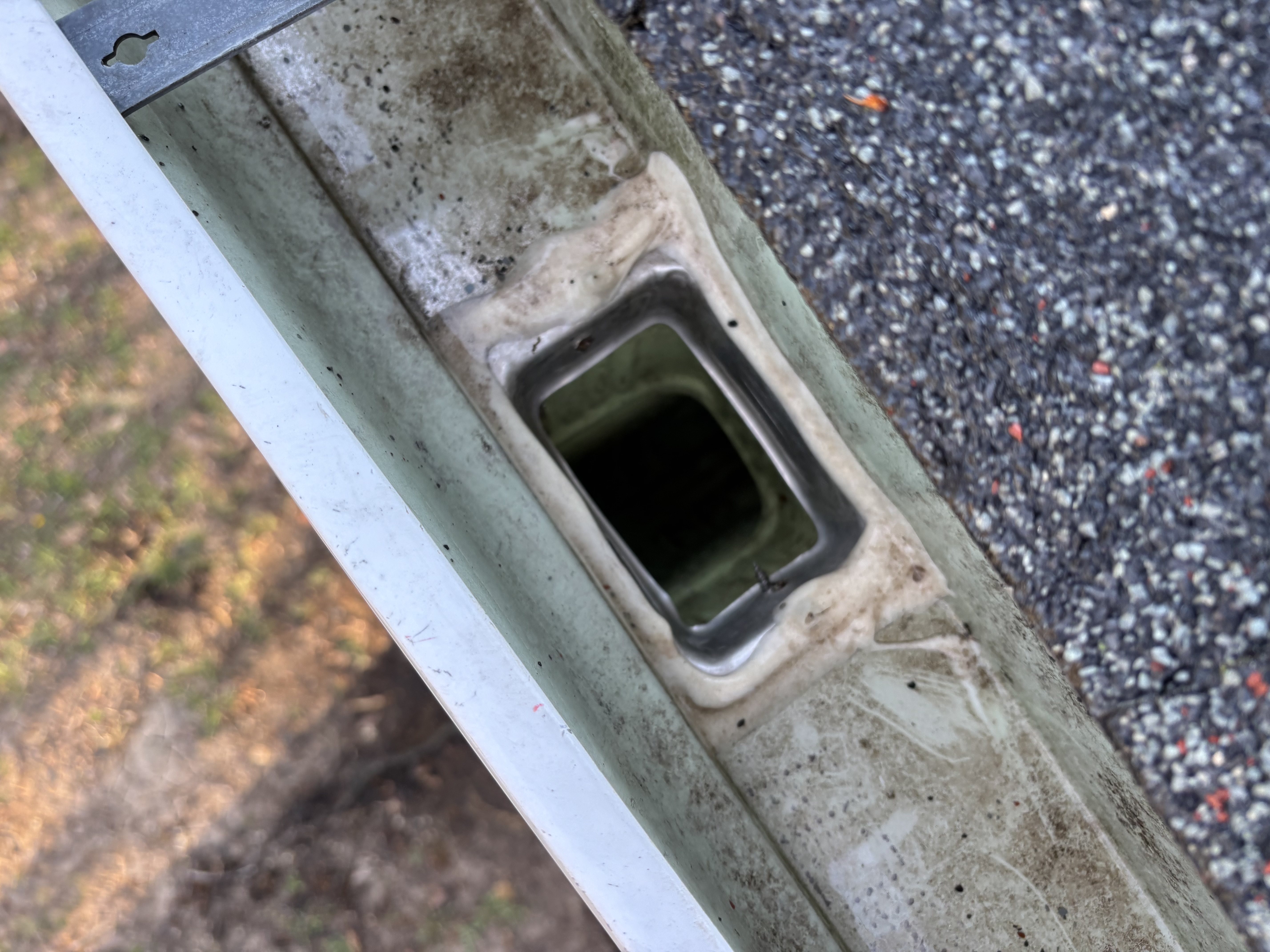 Downspout opening visible after cleaning