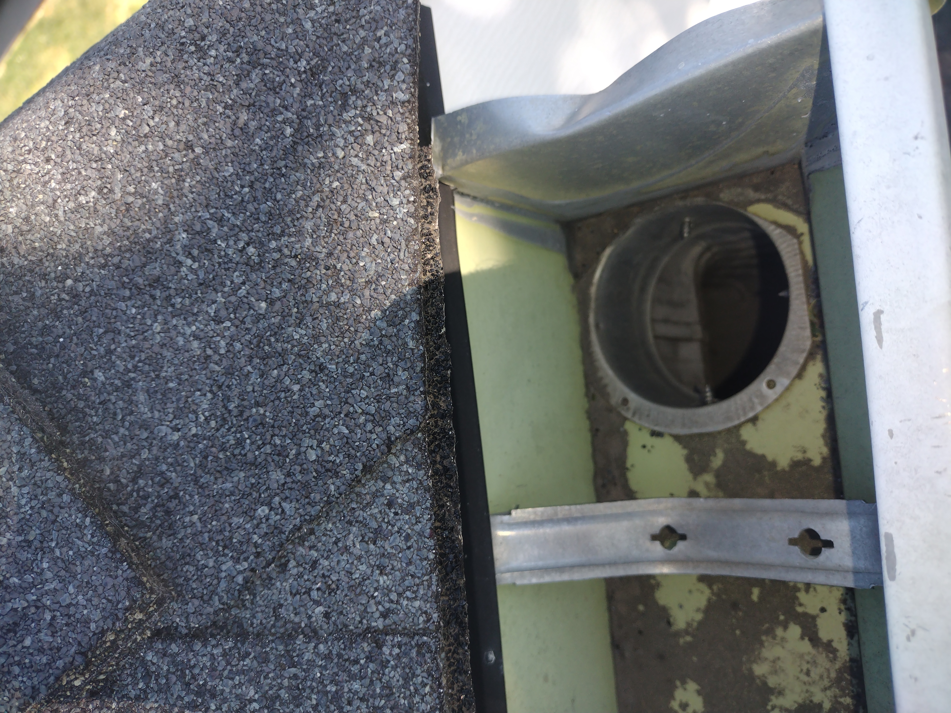 Downspout opening visible after cleaning on a Platte City home