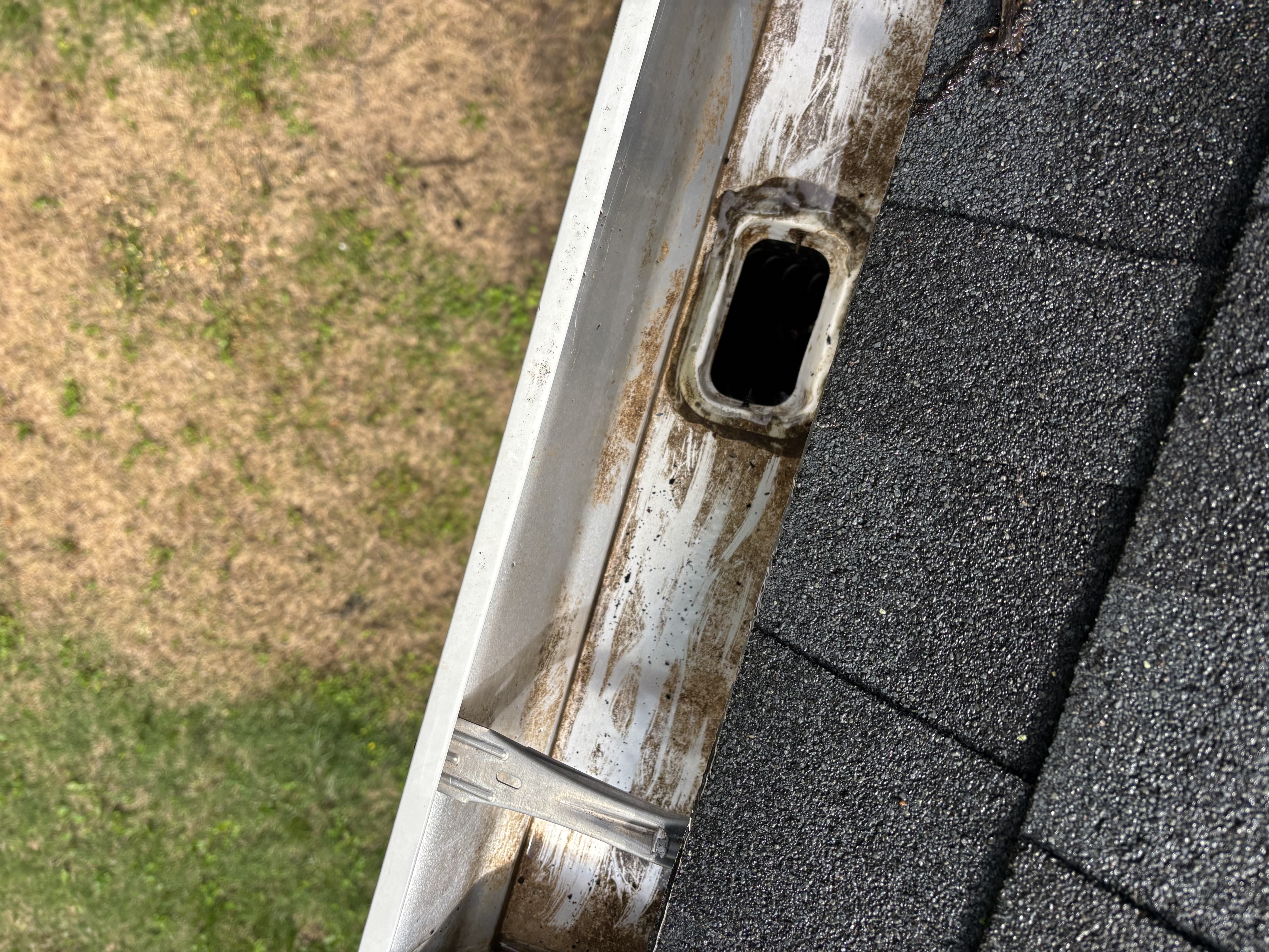 Close view of a cleared downspout outlet area