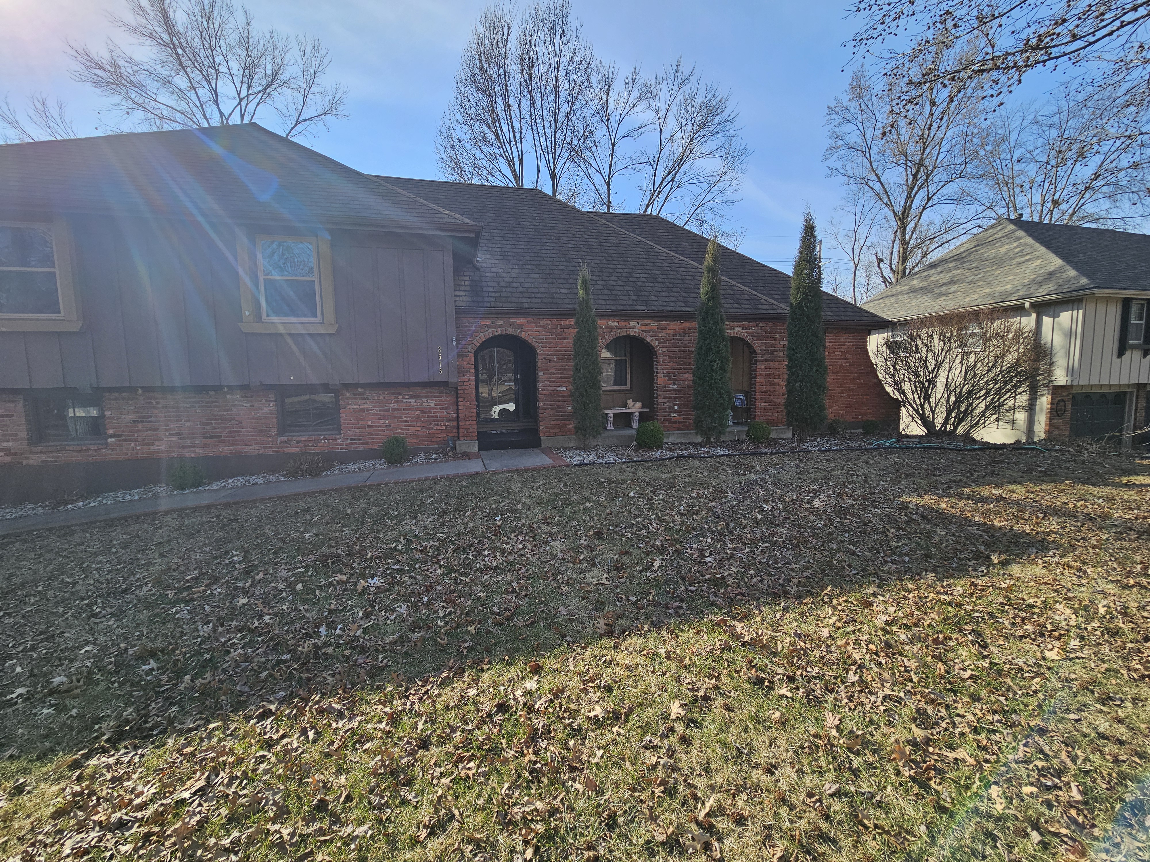 Two-story Kansas City home shown with surrounding yard and roof edge