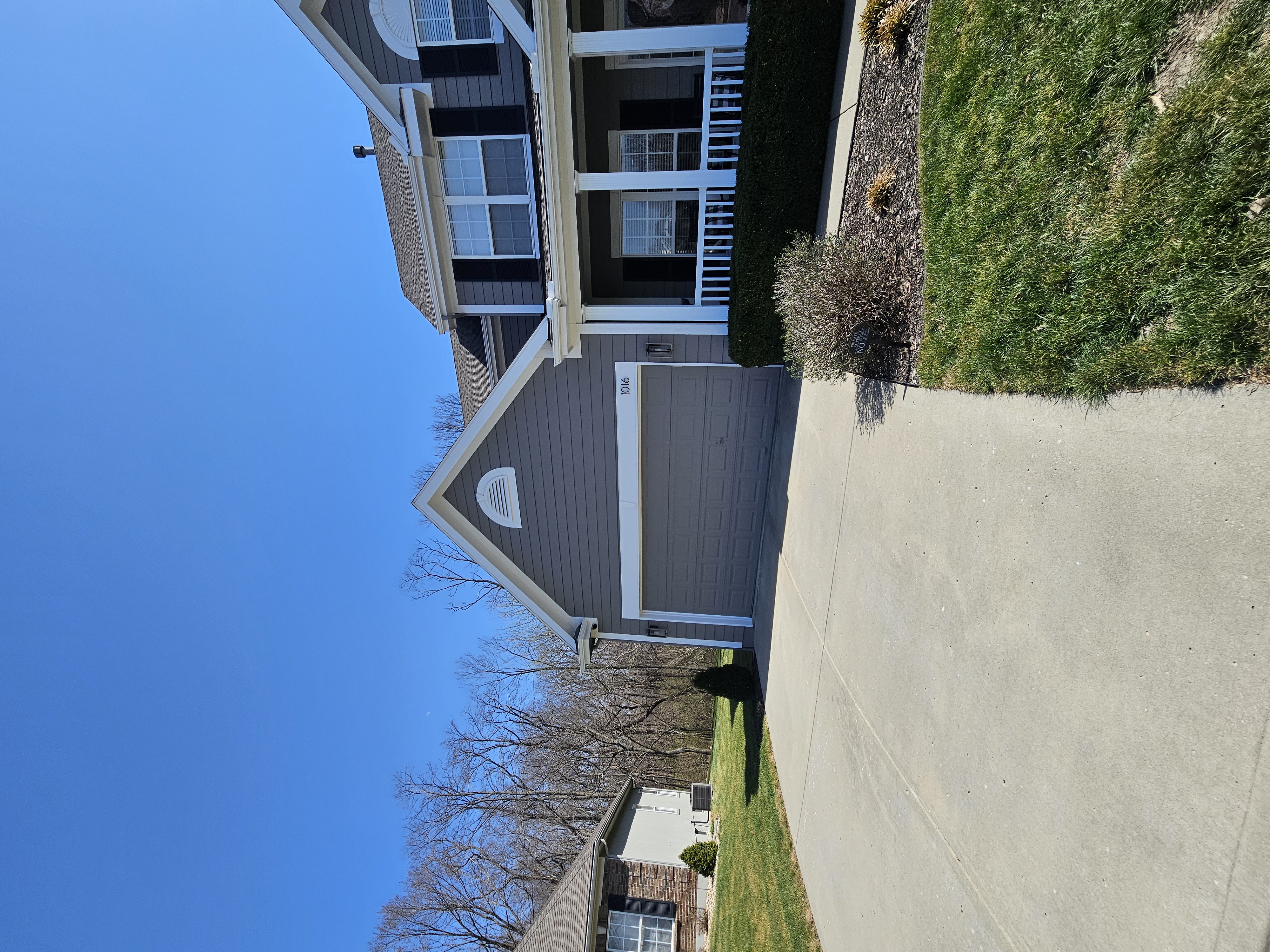 Front and side context showing height and garage area on a Liberty gutter cleaning job
