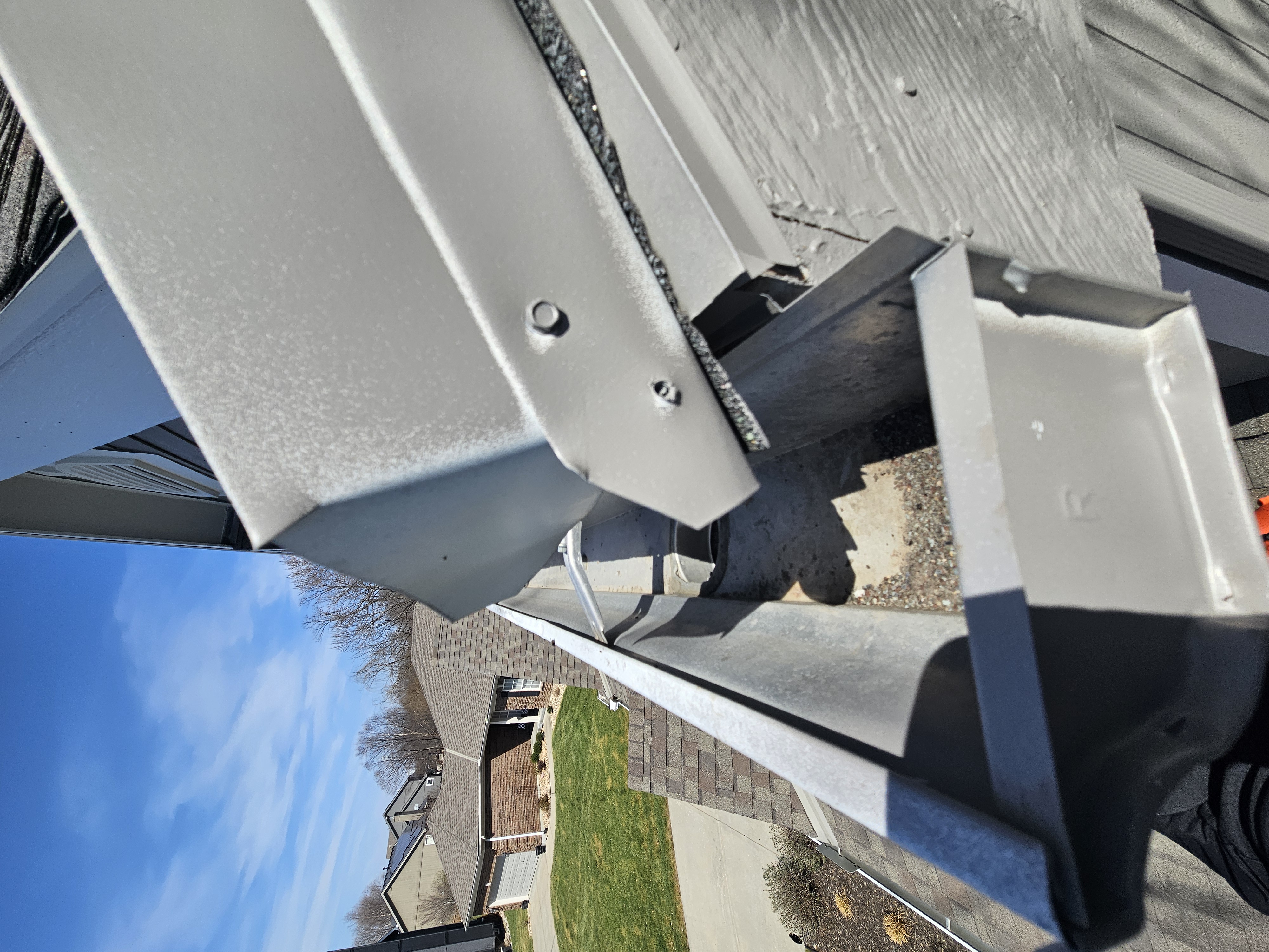 Upper gutter downspout opening at an elevated section